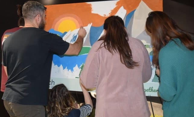 Large paint by number mural in progress at an event